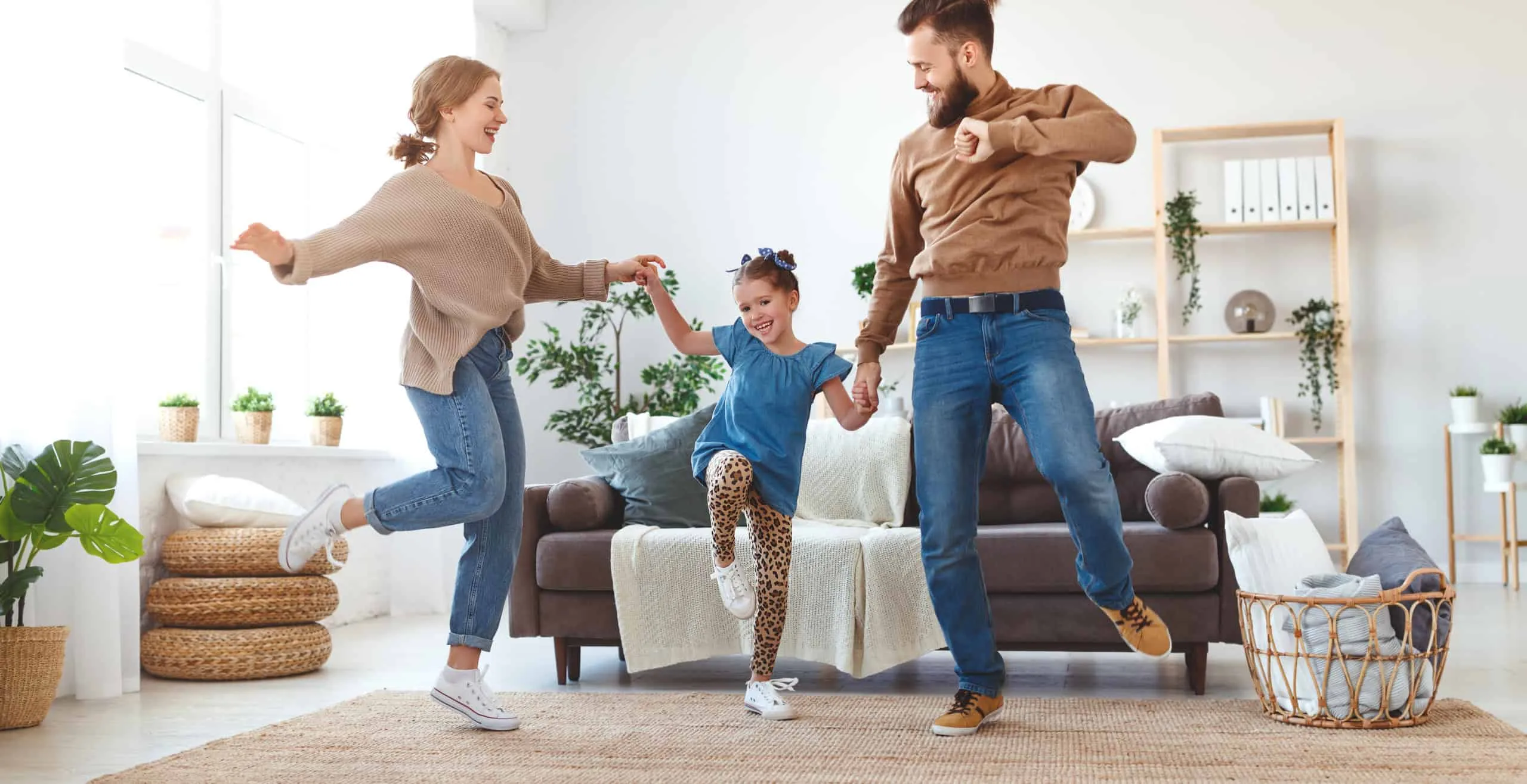 happy family mother father and child daughter dancing at home