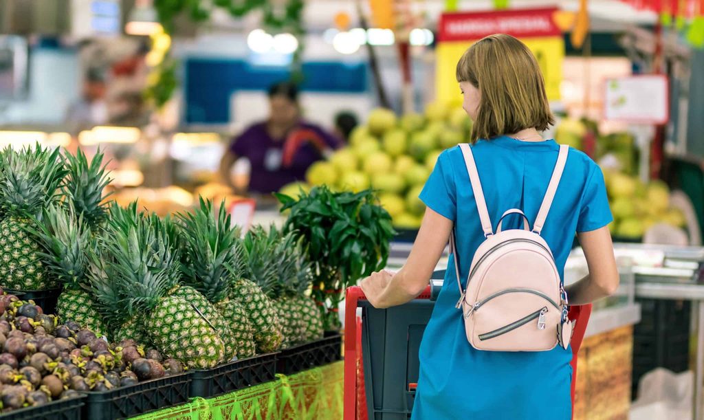 woman-standing-beside-pineapple-fruits-2292919-scaled